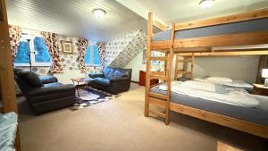 a bedroom with a bunk bed and a living room at Lledr House Hostel near two Zip World sites in Dolwyddelan