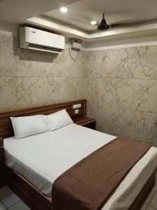 a bedroom with a bed and a tv on the wall at Leela Residency velankanni in Velankanni