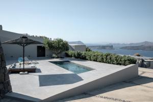a villa with a swimming pool and a view of the ocean at Melidonia Suites in Akrotiri