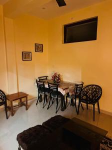 a living room with a table and chairs and a tv at The Hp 39 House in Dharmsāla +45 photos
