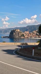 a road with a view of the ocean and a city at Stop And Go in Scilla