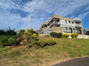 a building on top of a hill with a sign at Westbrook Cabanas 1st in Westbrook
