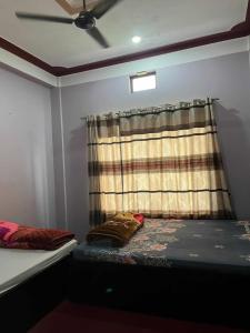 a small room with a bed and a window at Paradise Hotel & Lodge in Birtamod