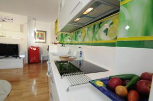 a kitchen with a sink and fruits on a counter at White Dream Suites in Iaşi