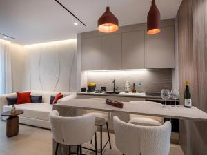 a kitchen and living room with a couch and a table at Space Row Exclusive Residences in Heraklio