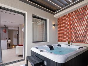 a bathroom with a large bath tub in a room at Space Row Exclusive Residences in Heraklio +83 photos