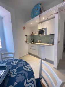 a kitchen with a table and a kitchen with a counter top at Trame - La Naca sul Porto in Polignano a Mare