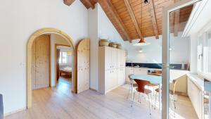 a kitchen and dining room with a table and chairs at Chesa Chatrigna App 9 - Celerina in Celerina