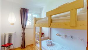 a bedroom with two bunk beds in a room at Chesa Chatrigna App 9 - Celerina in Celerina