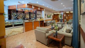a living room with couches and a counter in a store at Marsa Diba Hotel in Ḑubā