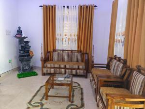 a living room with two couches and a coffee table at Galoya Red Lotus in Ampara +18 photos