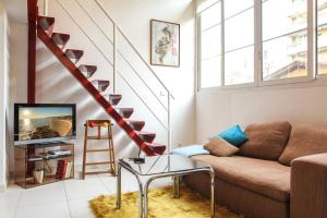 a living room with a couch and a staircase at MY CASA FRANCE 841 - parking in Nice
