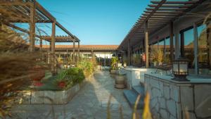 a patio with potted plants and a building at Marsa Diba Hotel in Ḑubā