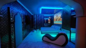 a room with a bed and a blue light at C rooms - Suite a tema con vasca - Motel Monza in Cinisello Balsamo +36 photos