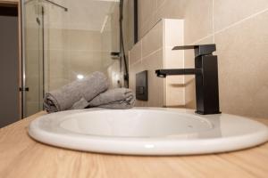 a sink with a faucet in a bathroom at Apartmán Istebné luxure in Istebné
