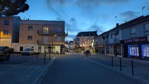an empty street in a city at night at Cocon moderne avec terrasse a deux pas de locean in Saint-Brevin-les-Pins