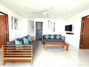 a living room with a couch and a tv at Villa Putih in Lovina
