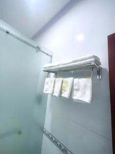a bathroom with white towels on a rack at Diamond Suite Dai Nam Hotel in Can Tho +54 photos
