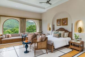 a bedroom with a bed and a large window at Dev Bagh Luxurious Private Suites in Debāri +56 photos