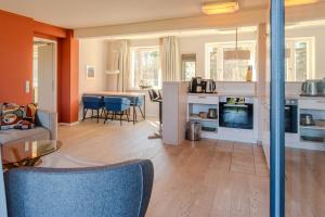 a living room with a couch and a dining room at Lachmöwe B1-311 mit Meerblick und Balkon in Binz +13 photos