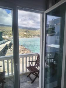 a balcony with chairs and a view of the ocean at Nautilus andros house in Andros +15 photos