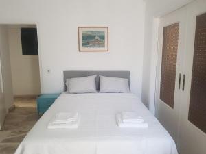 a bedroom with a bed with two white pillows at Nautilus andros house in Andros