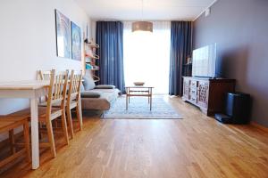 a living room with a table and a dining room at Modern apartement with a balcony in Tallinn
