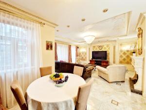 a living room with a table and chairs at Villa Eternity in Jūrmala