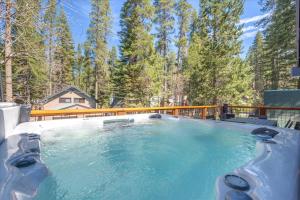 a hot tub on a deck with trees at Donner Lake Outpost home in Truckee
