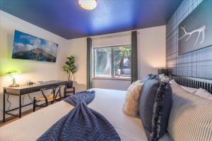 a bedroom with a bed and a desk and a window at Donner Lake Outpost home in Truckee