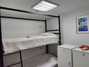a bedroom with two bunk beds and a mirror at Солензара in Mukacheve