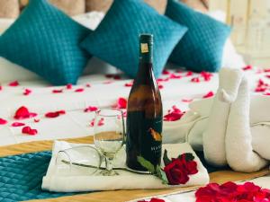 a bottle of wine and a glass on a table at Mita Hotel - Land of Himalayas in Dhulikhel