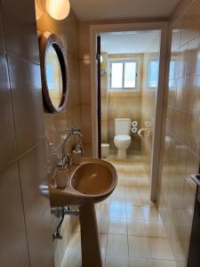 a bathroom with a sink and a toilet at City Vibes - Central 3BR Spacious Apartment in Larnaca