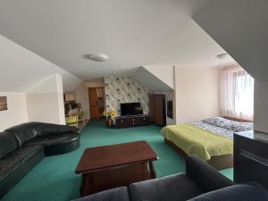 a large living room with a bed and a couch at Apartamenty LeVilla in Rewa