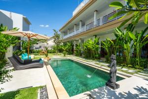 a swimming pool in the backyard of a house at Maha Prana Kedungu by Aayan in Tanah Lot