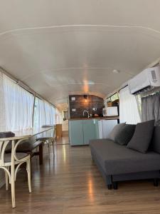 a living room and dining room in an rv at צימרים בצפון - קאמפ דיוויד in Sheʼar Yashuv