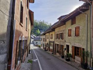 an empty street in an old town with buildings at Le refuge des deux âmes in Alby +3 photos