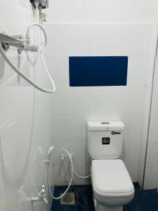 a bathroom with a white toilet and a shower at Galeena Guest in Badulla