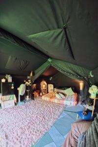 a green tent with two beds in it at Le Rafting & Le Camping in Ban Hin Dan +7 photos