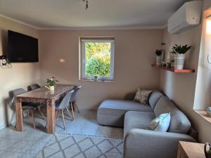 a living room with a couch and a table at Tóthék Apartman in Szigetvár