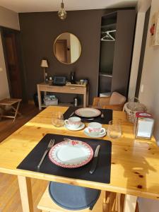 a wooden table with a plate on top of it at La Suite Des Pervenches in Spa +15 photos