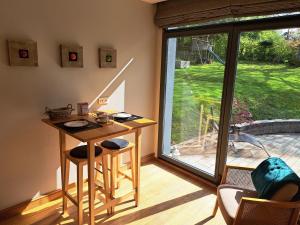 a room with a desk and a sliding glass door at La Suite Des Pervenches in Spa