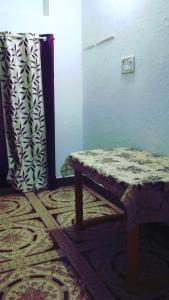 a bench sitting in a room with a window at Shri chitrakoot homestay in Chitrakoot
