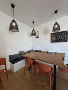 a dining room with a wooden table and chairs at Hotel La Casa , Le Barcarès in Le Barcarès