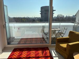 a room with a balcony with a couch and a table at Augarten in Vienna