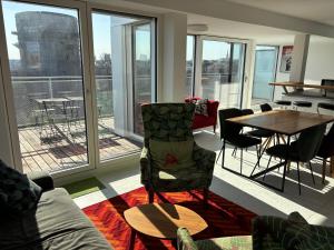 a living room with a couch and a table and windows at Augarten in Vienna