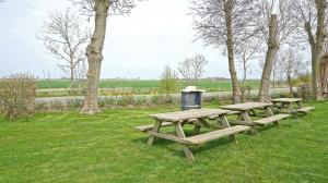 three picnic tables in a park with a trash can at Immensee App E in Böhl