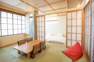 a dining room with a table and a bed at The Address Akakura in Myoko +56 photos