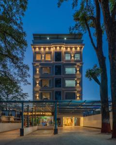 a tall building with lights on it at night at Perfectstayz Premium Aurevva, Rajpur road in Rājpur