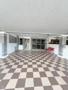 a room with a checkered floor and a red bench at Kings Park Homestay in Ipoh